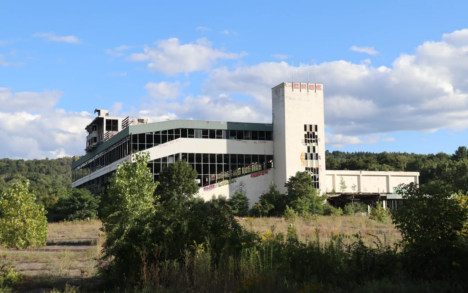 A dynamic motorsports racetrack with banked curves and grandstands